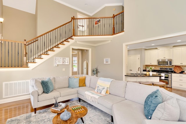 3429 Willow Lake Cir, Chattanooga, TN 37419 - living area with a high ceiling, light wood-type flooring, stairway, ornamental molding, and recessed lighting