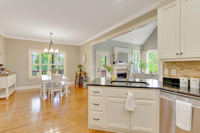 3429 Willow Lake Cir, Chattanooga, TN 37419 - kitchen featuring stainless steel dishwasher, a chandelier, a fireplace, a peninsula, and pendant lighting