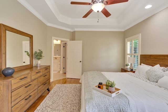 3429 Willow Lake Cir, Chattanooga, TN 37419 - bedroom featuring a raised ceiling, light wood-type flooring, ornamental molding, ensuite bath, and ceiling fan