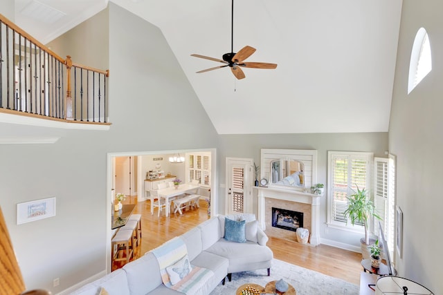 3429 Willow Lake Cir, Chattanooga, TN 37419 - living area featuring high vaulted ceiling, wood finished floors, a ceiling fan, a fireplace, and a chandelier