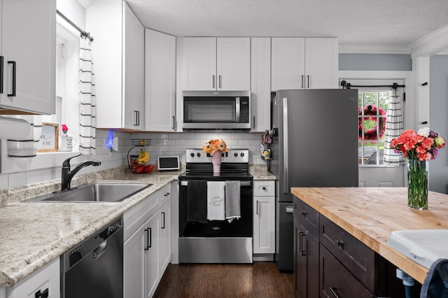 142 Jones Dr, Dunlap, TN 37327 - kitchen with appliances with stainless steel finishes, wood counters, a sink, white cabinetry, and a textured ceiling