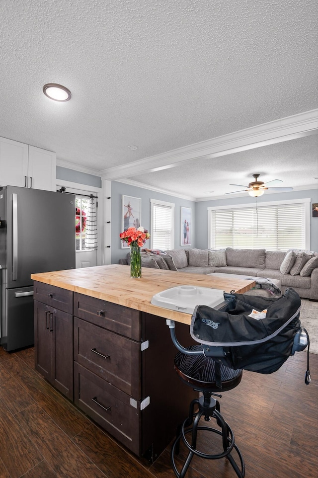 142 Jones Dr, Dunlap, TN 37327 - kitchen with butcher block counters, freestanding refrigerator, open floor plan, ornamental molding, and a textured ceiling