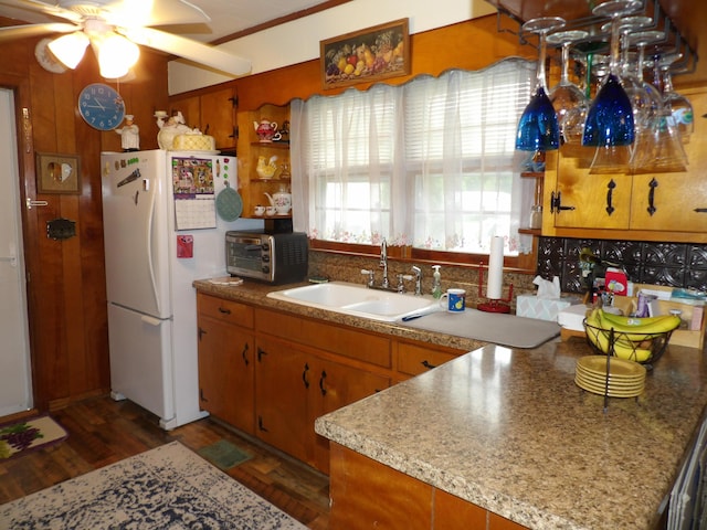 634 Bellvue Cir, Spencer, TN 38585 - kitchen with freestanding refrigerator, dark wood-style flooring, a sink, ceiling fan, and brown cabinets