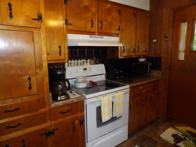 634 Bellvue Cir, Spencer, TN 38585 - kitchen featuring white electric range oven, under cabinet range hood, black microwave, brown cabinetry, and decorative backsplash