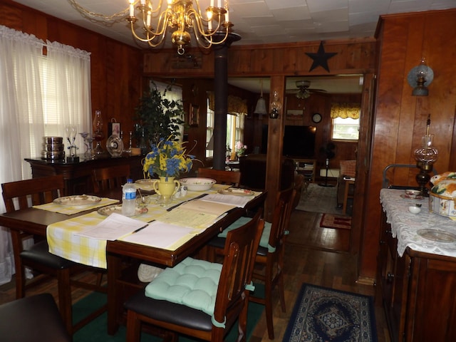 634 Bellvue Cir, Spencer, TN 38585 - dining area featuring wooden walls, a chandelier, a ceiling fan, and wood finished floors