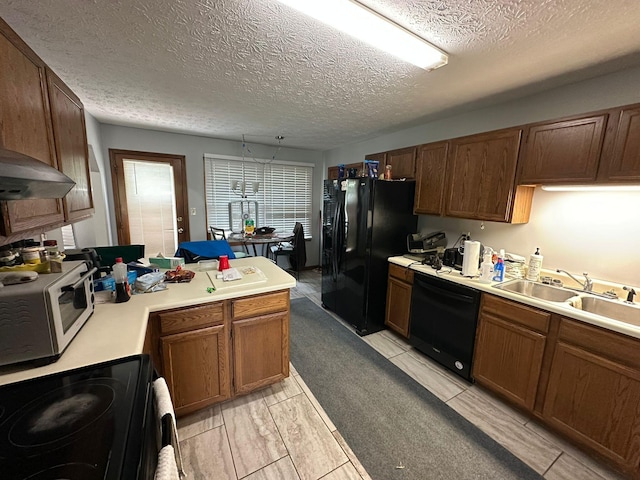 516 Keck St, Seymour, TN 37865 - kitchen featuring black appliances, a sink, light countertops, a textured ceiling, and a peninsula