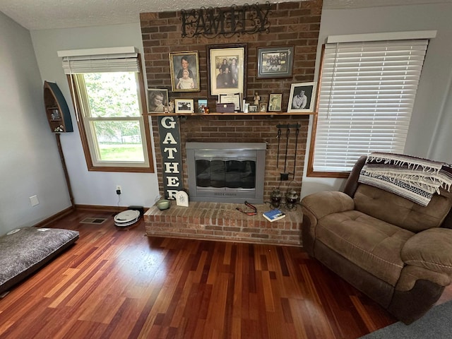 516 Keck St, Seymour, TN 37865 - living room featuring a fireplace, wood finished floors, baseboards, and a textured ceiling