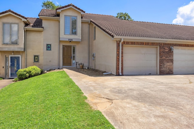 2138 Vaden Village Dr, Chattanooga, TN 37421 - view of front of house with driveway, stucco siding, an attached garage, and a front yard