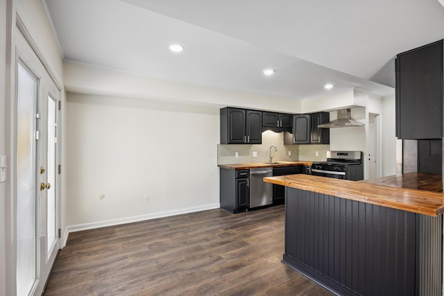 2138 Vaden Village Dr, Chattanooga, TN 37421 - kitchen with wooden counters, stainless steel appliances, wall chimney exhaust hood, backsplash, and recessed lighting