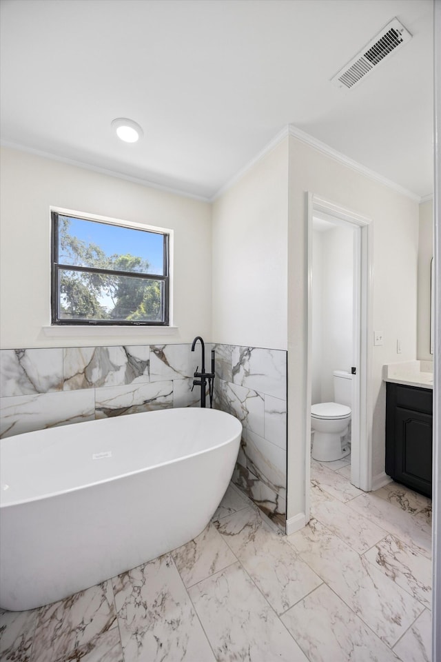 2138 Vaden Village Dr, Chattanooga, TN 37421 - bathroom featuring tile walls, vanity, a freestanding bath, crown molding, and marble finish floors