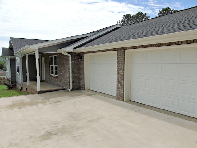 135 Joseph Daniel Ln, Jasper, TN 37347 - view of front of house featuring concrete driveway, a garage, a shingled roof, and brick siding