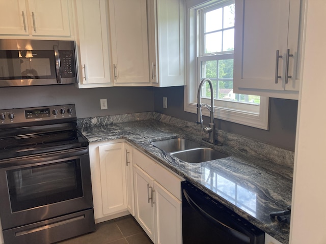 135 Joseph Daniel Ln, Jasper, TN 37347 - kitchen featuring stainless steel appliances, white cabinetry, dark stone counters, and dark tile patterned flooring