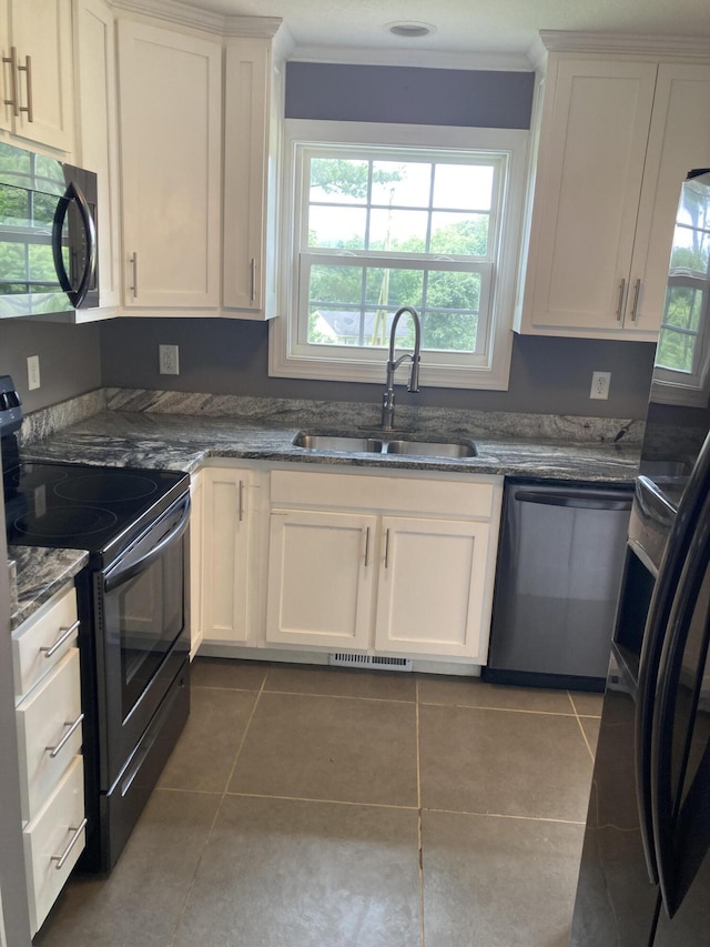 135 Joseph Daniel Ln, Jasper, TN 37347 - kitchen featuring black appliances, tile patterned flooring, white cabinets, healthy amount of natural light, and ornamental molding