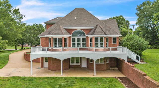 4155 Freewill Rd NW, Cleveland, TN 37312 - rear view of property with brick siding, a patio area, and a yard