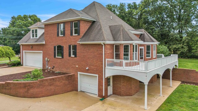 4155 Freewill Rd NW, Cleveland, TN 37312 - rear view of house featuring a garage, brick siding, a shingled roof, and driveway