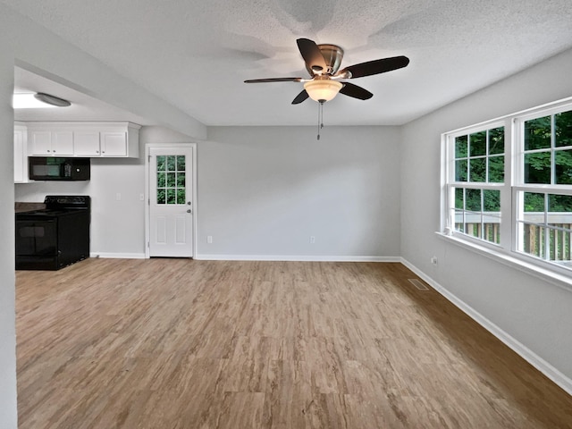 6562 Esquire Ln, Hixson, TN 37343 - unfurnished living room featuring ceiling fan, baseboards, light wood finished floors, and a textured ceiling