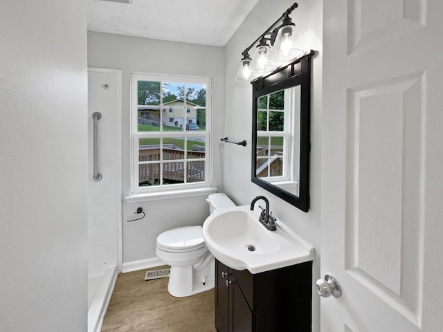 6562 Esquire Ln, Hixson, TN 37343 - full bathroom featuring vanity, wood finished floors, toilet, baseboards, and a shower