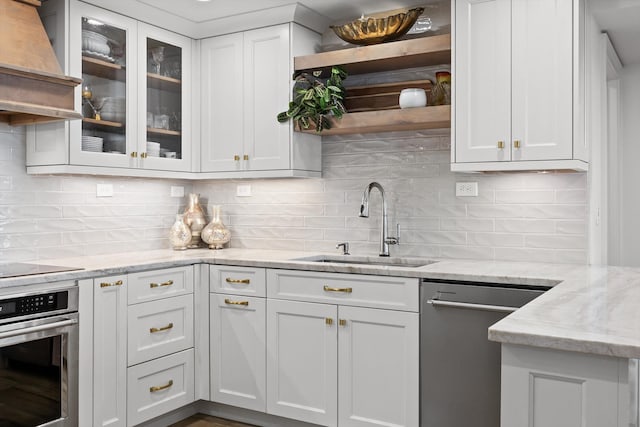 1131 Stringers Ridge Rd Unit 12E, Chattanooga, TN 37405 - kitchen with appliances with stainless steel finishes, premium range hood, a sink, white cabinets, and decorative backsplash