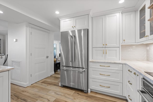 1131 Stringers Ridge Rd Unit 12E, Chattanooga, TN 37405 - kitchen featuring stainless steel appliances, white cabinetry, light wood-style floors, recessed lighting, and glass insert cabinets