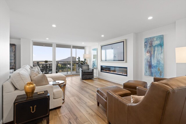 1131 Stringers Ridge Rd Unit 12E, Chattanooga, TN 37405 - living area with light wood-style flooring, a glass covered fireplace, recessed lighting, and floor to ceiling windows