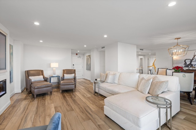 1131 Stringers Ridge Rd Unit 12E, Chattanooga, TN 37405 - living room with recessed lighting, light wood-style flooring, a chandelier, a glass covered fireplace, and baseboards