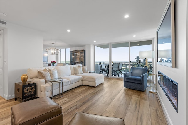 1131 Stringers Ridge Rd Unit 12E, Chattanooga, TN 37405 - living area with light wood-style flooring, a chandelier, baseboards, recessed lighting, and a wall of windows
