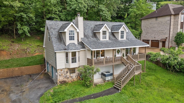 1714 S Crest Manor Ln, Chattanooga, TN 37404 - view of front facade featuring an attached garage, asphalt driveway, a chimney, a porch, and a front yard