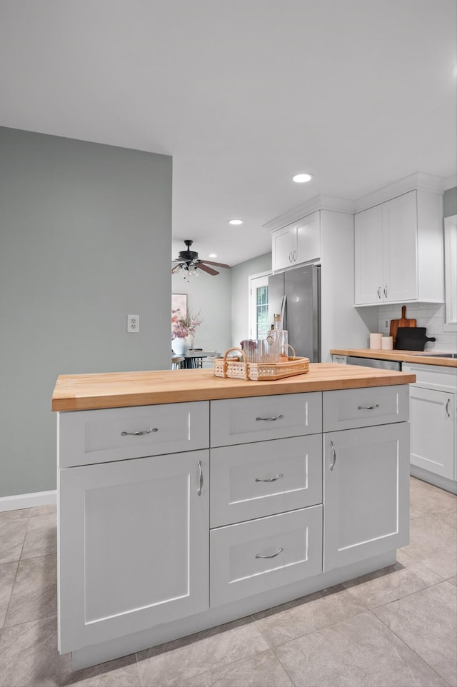1714 S Crest Manor Ln, Chattanooga, TN 37404 - kitchen with freestanding refrigerator, butcher block countertops, white cabinetry, recessed lighting, and ceiling fan