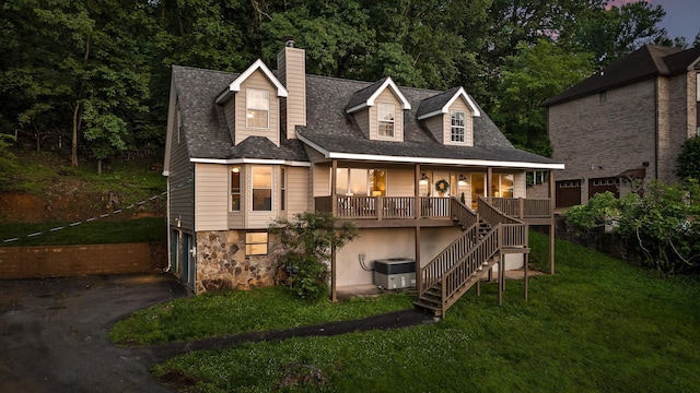 1714 S Crest Manor Ln, Chattanooga, TN 37404 - view of front facade with a chimney, stairs, a garage, asphalt driveway, and a front lawn
