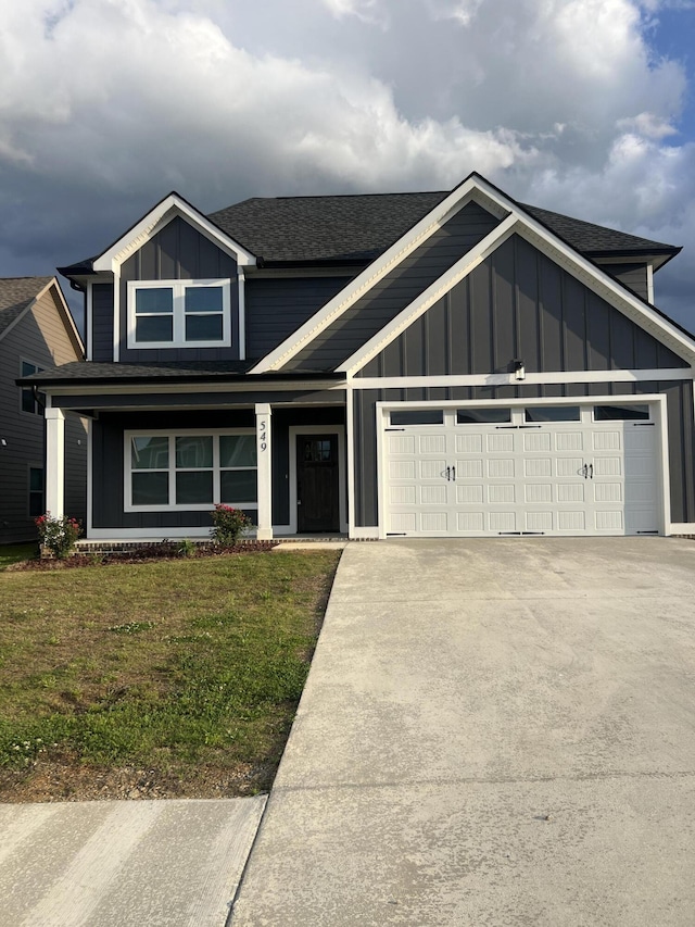 549 Willow Grv Ct Unit 69, Ringgold, GA 30736 - view of front of property featuring board and batten siding, a garage, a front lawn, concrete driveway, and roof with shingles