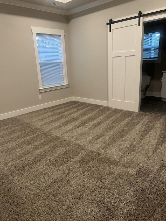 549 Willow Grv Ct Unit 69, Ringgold, GA 30736 - unfurnished bedroom featuring dark colored carpet, a barn door, baseboards, and crown molding