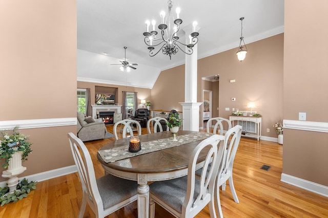 4322 Wellesley Dr, Ooltewah, TN 37363 - dining area featuring ceiling fan, crown molding, a lit fireplace, decorative columns, and light wood finished floors