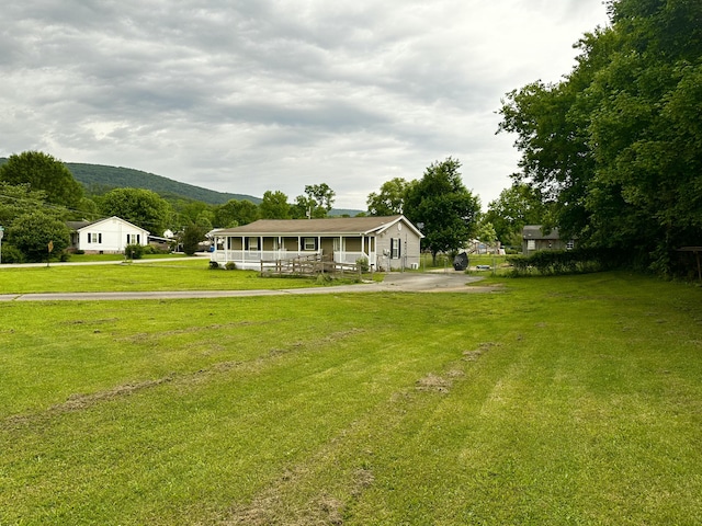 219 Igou Ferry Rd, Soddy Daisy, TN 37379 - view of front facade with a mountain view, a porch, a front yard, and driveway