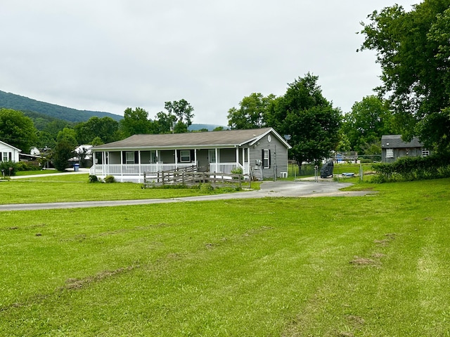 219 Igou Ferry Rd, Soddy Daisy, TN 37379 - view of front of home with a porch, a front lawn, and a mountain view