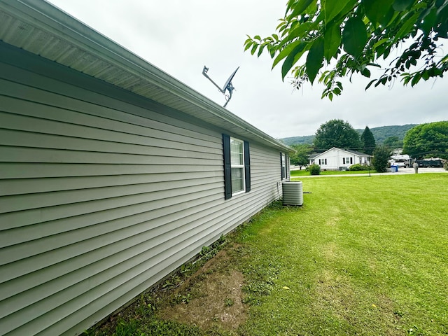 219 Igou Ferry Rd, Soddy Daisy, TN 37379 - view of side of home with central AC and a yard