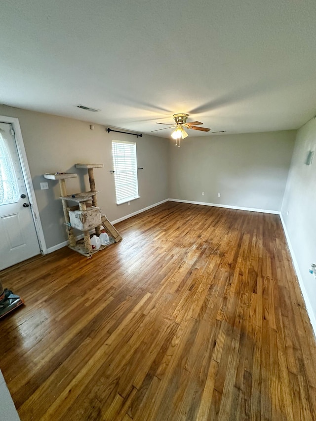 219 Igou Ferry Rd, Soddy Daisy, TN 37379 - unfurnished living room with wood finished floors, a ceiling fan, and baseboards