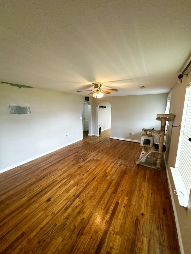 219 Igou Ferry Rd, Soddy Daisy, TN 37379 - unfurnished living room featuring wood finished floors, ceiling fan, and baseboards