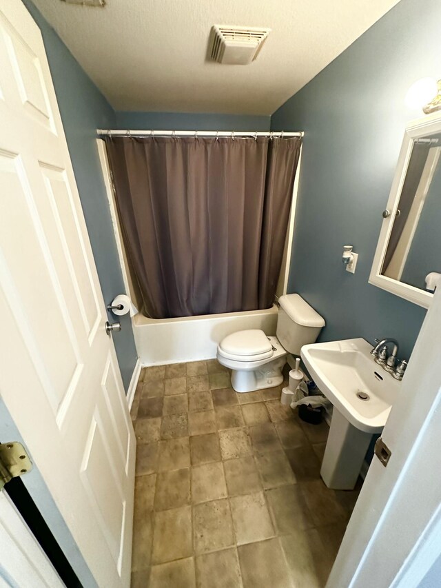 219 Igou Ferry Rd, Soddy Daisy, TN 37379 - full bath featuring toilet, shower / bathtub combination with curtain, and a sink
