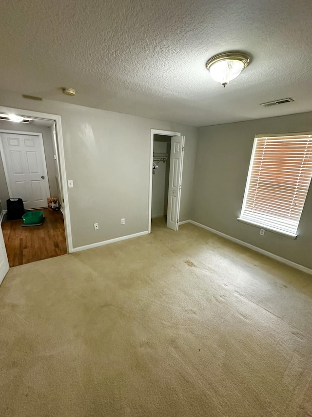 219 Igou Ferry Rd, Soddy Daisy, TN 37379 - unfurnished bedroom featuring a textured ceiling, carpet, baseboards, and a closet
