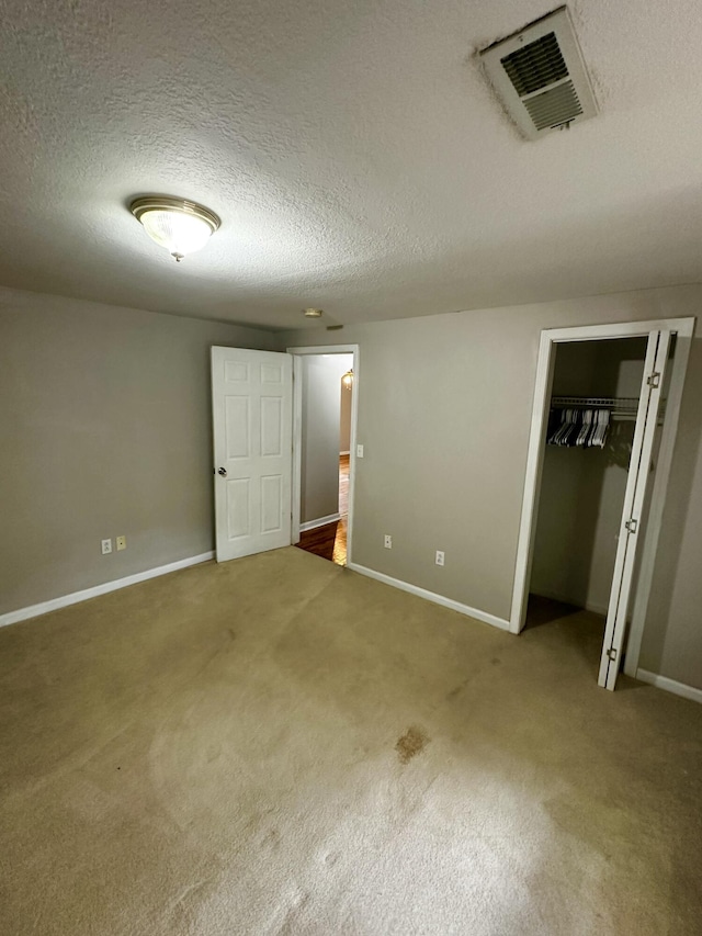 219 Igou Ferry Rd, Soddy Daisy, TN 37379 - unfurnished bedroom featuring a textured ceiling, baseboards, carpet flooring, and a closet