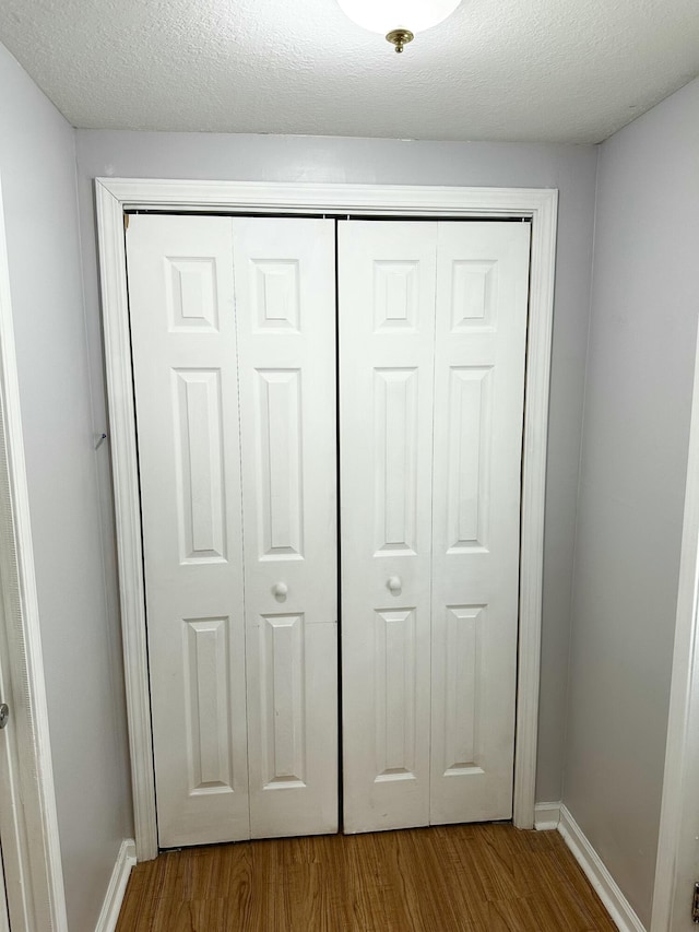 219 Igou Ferry Rd, Soddy Daisy, TN 37379 - detailed view of wood finished floors, baseboards, and a textured ceiling