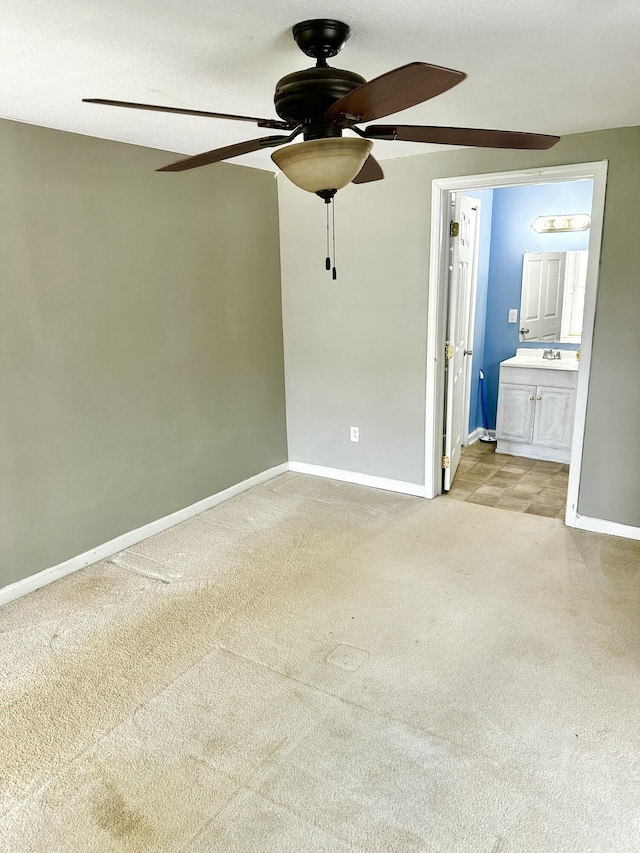 219 Igou Ferry Rd, Soddy Daisy, TN 37379 - unfurnished bedroom featuring light colored carpet, baseboards, ensuite bathroom, ceiling fan, and a sink