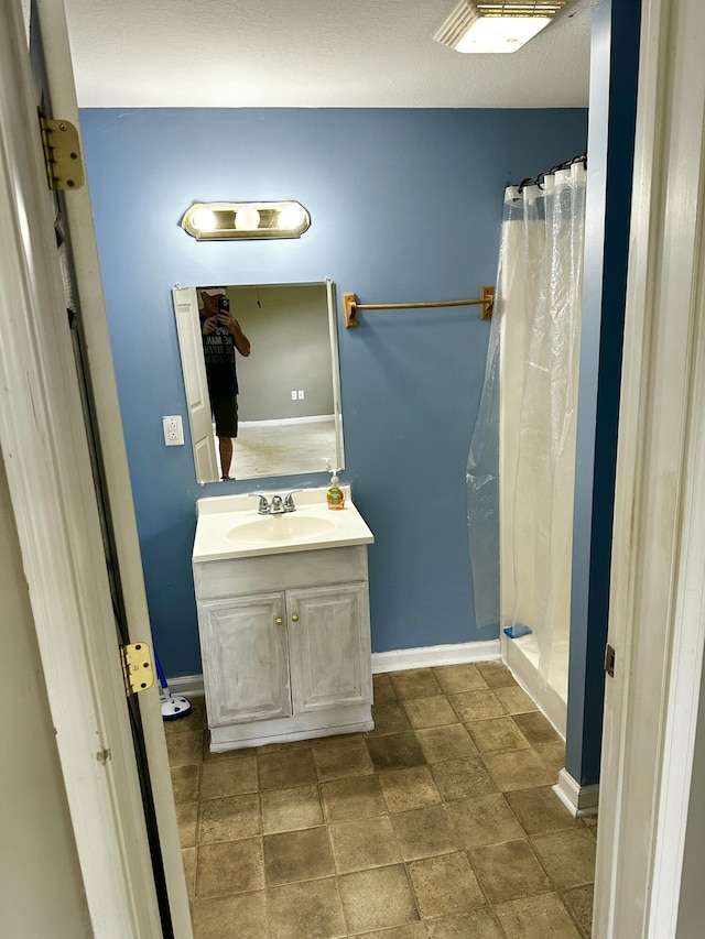 219 Igou Ferry Rd, Soddy Daisy, TN 37379 - bathroom with vanity, a stall shower, and baseboards