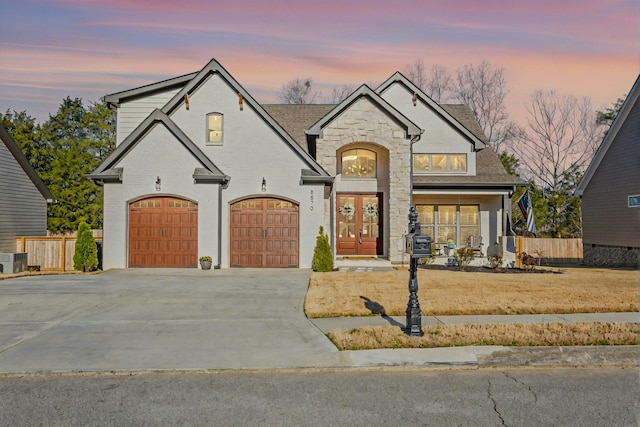 8870 Silver Maple Dr, Ooltewah, TN 37363 - french country home with driveway, stone siding, french doors, and a shingled roof