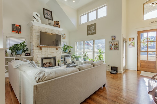 8870 Silver Maple Dr, Ooltewah, TN 37363 - living area with a high ceiling, plenty of natural light, wood finished floors, baseboards, and a stone fireplace