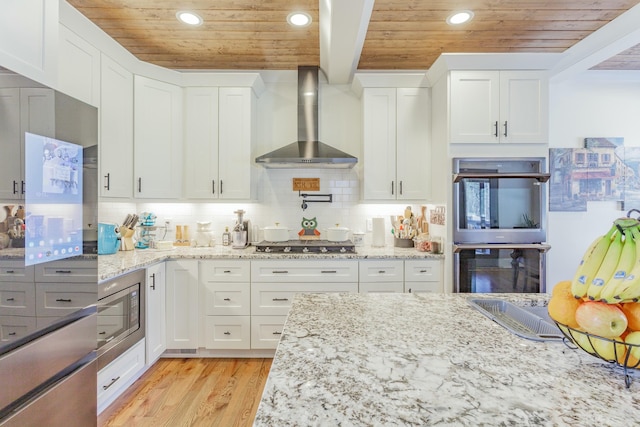 8870 Silver Maple Dr, Ooltewah, TN 37363 - kitchen featuring wall chimney range hood, wooden ceiling with exposed beams, appliances with stainless steel finishes, recessed lighting, and white cabinetry