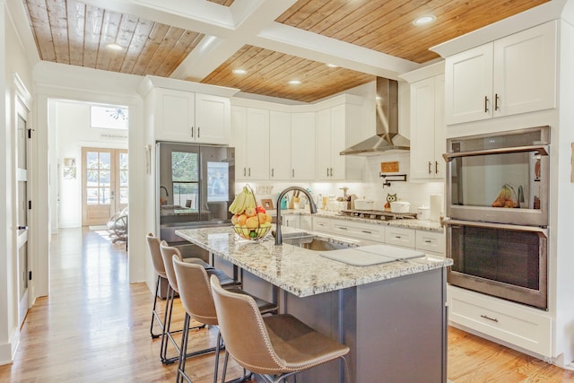 8870 Silver Maple Dr, Ooltewah, TN 37363 - kitchen with appliances with stainless steel finishes, wood ceiling with exposed beams, wall chimney exhaust hood, a sink, and decorative backsplash