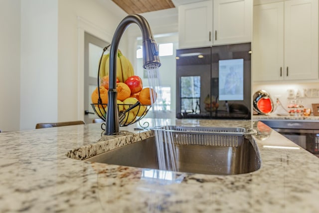 8870 Silver Maple Dr, Ooltewah, TN 37363 - kitchen featuring light stone counters, white cabinets, and wall oven