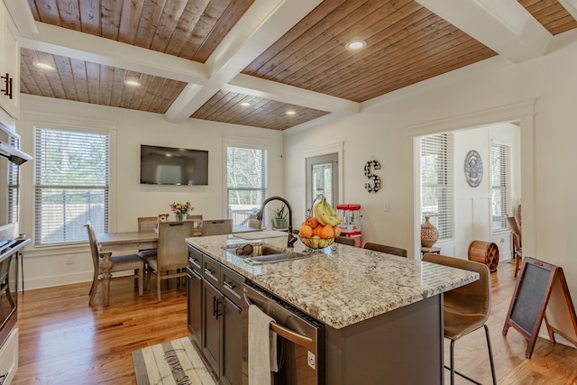 8870 Silver Maple Dr, Ooltewah, TN 37363 - kitchen with a sink, light wood-style floors, a breakfast bar area, light stone countertops, and recessed lighting