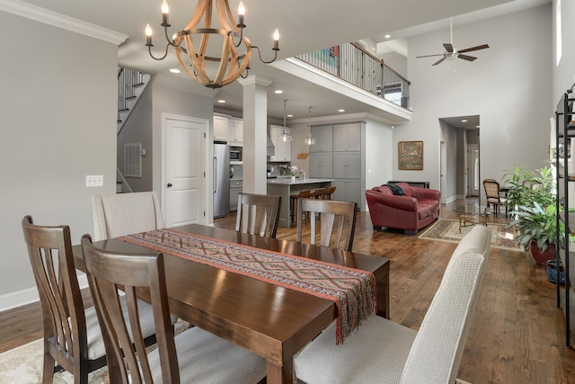 1676 Westover Ln, Chattanooga, TN 37405 - dining room with wood finished floors, a chandelier, baseboards, ceiling fan, and stairs